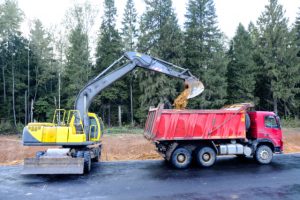 Portland Dump Truck with an excavator loading